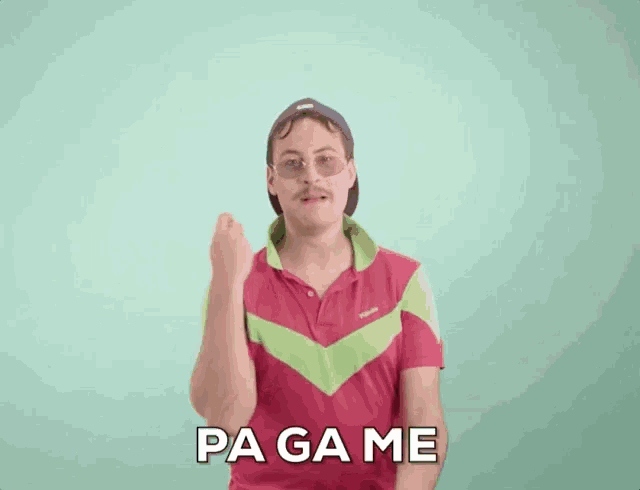 a man in a pink and green shirt is clapping his hands and says " pa game " in white letters