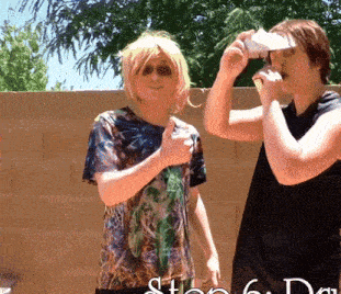 a couple of people standing next to each other with a sign that says step 6 da