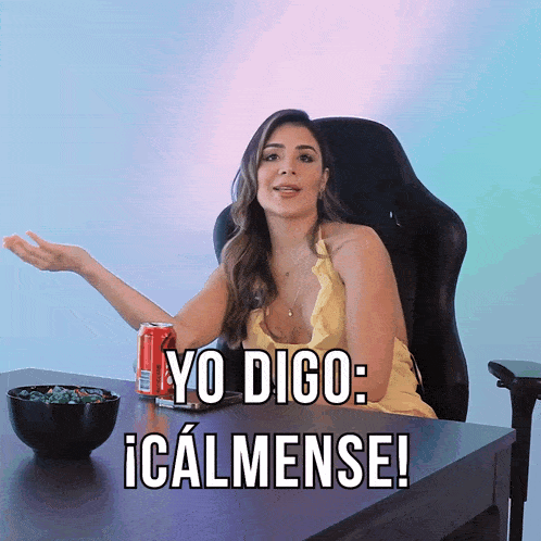a woman sits at a desk with a can of coca cola and a bowl of candy and says yo digo icalmense
