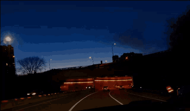 a car is driving down the highway at night