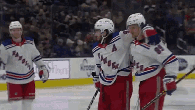 a group of hockey players are standing on the ice and one player has the number 4 on his jersey