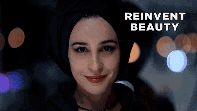 a woman wearing a hijab is smiling with the words reinvent beauty behind her