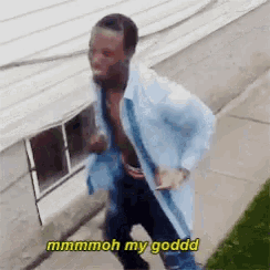 a man in a blue shirt is running down a sidewalk with the words mmmmoh my goddd written above him .