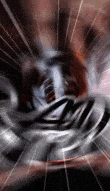 a person is spinning a metal object in a dark room