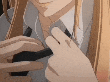 a close up of a person adjusting their shirt and tie
