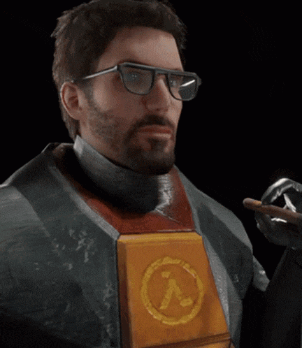 a man with a beard wearing glasses and a half life logo on his chest