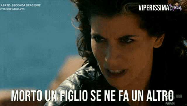 a picture of a woman with the words " morto un figlio se ne fa un altro " below her