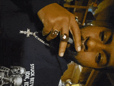 a man wearing a black shirt that says stuck between idk and id