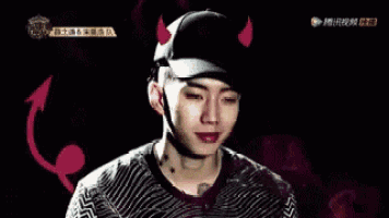 a young man wearing a hat with red horns and a devil tail .