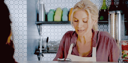 a woman wearing an apron says " trust me "