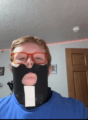 a man wearing glasses and a mask with a hole in it