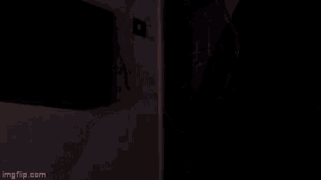 a woman with purple hair is making a funny face in the dark .