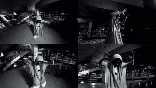 a black and white photo of a man in a hoodie