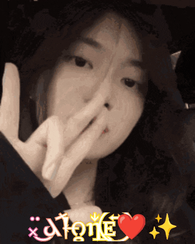 a girl making a peace sign with the word alone in the corner