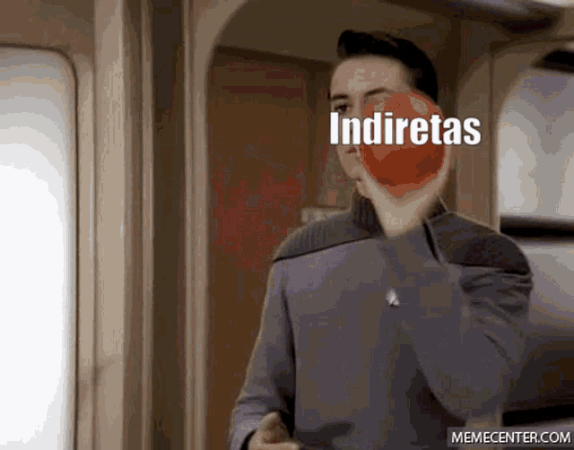 a man is holding a red apple with the word indiretas written on it