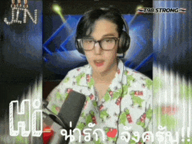 a man wearing glasses and headphones says hi in a foreign language