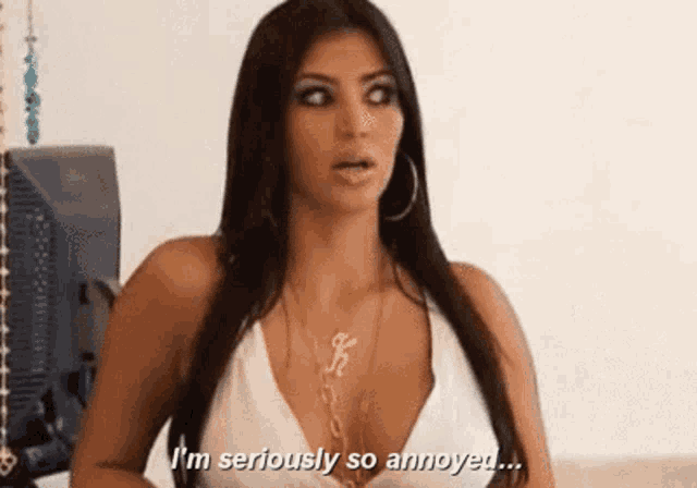 a woman in a white top is saying i 'm seriously so annoyed ...