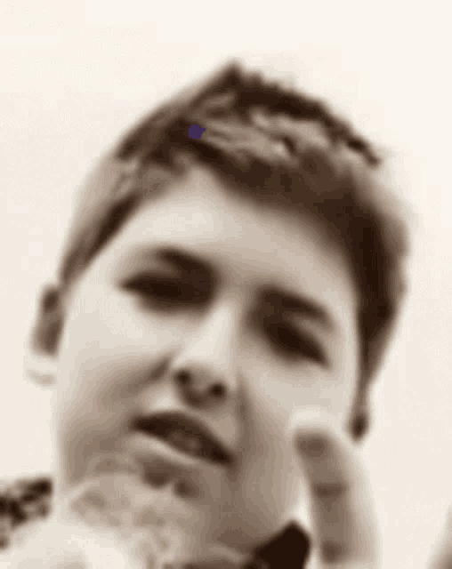 a black and white photo of a young boy giving a thumbs up sign .