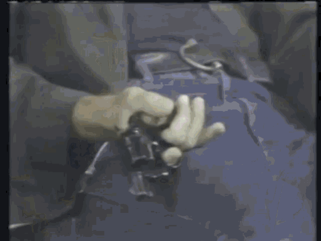 a close up of a person holding a gun with a burst of light coming out of it