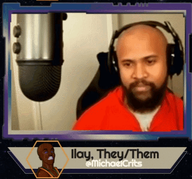 a man with a beard is wearing headphones in front of a microphone with the caption illay they them @michaelcrits