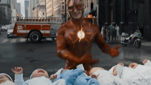 a man in a flash costume is standing in front of a fire truck