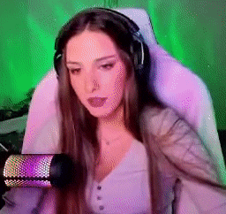 a woman wearing headphones is sitting in front of a microphone .