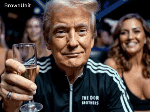 a man wearing a jacket that says the dor brothers is holding a glass of wine