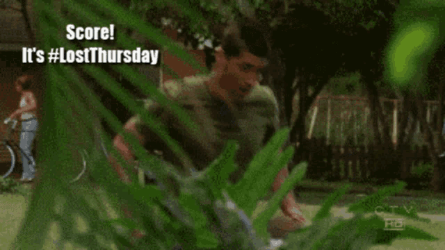 a man in a green shirt with the words score it 's #lostthursday
