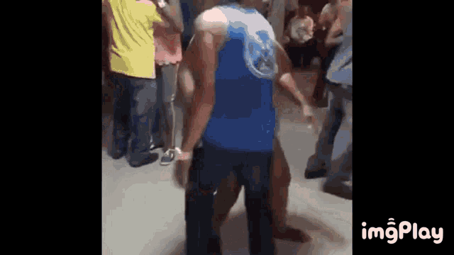 a group of people are dancing in a room .