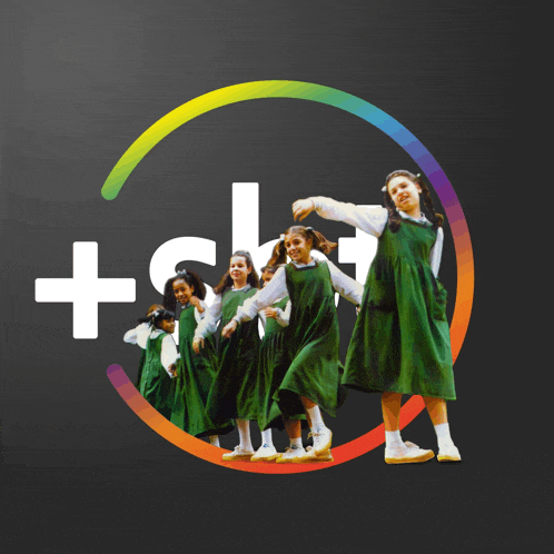 a group of girls in green overalls are dancing in a circle with a plus sign