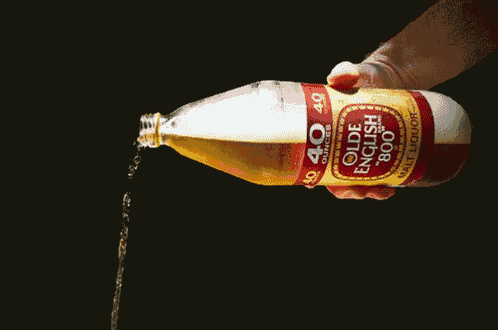 a bottle of olde english 800 malt liquor is being poured into a glass