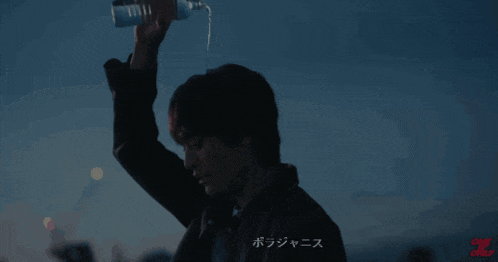 a man holds a bottle of water over his head with the word one on the bottom
