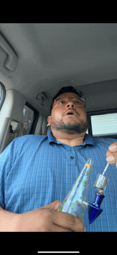 a man in a blue plaid shirt is smoking a pipe