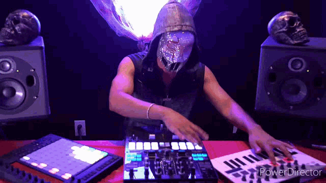 a man wearing a mask is playing music on a mixer with the words power director on the bottom right