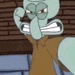 squidward from spongebob squarepants is standing in front of a brick wall with his fist in the air .