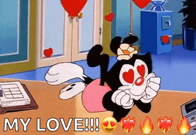 a cartoon character with heart shaped eyes is laying on a desk with hearts flying around her .