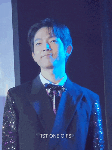 a gif of a man in a suit with the words 1st one gifs on the bottom