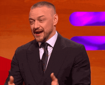a man with a beard wearing a suit and tie