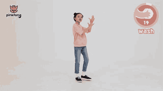 a girl is dancing in front of a sign that says wash