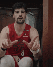 a man in a red basketball jersey with the number 8 on it