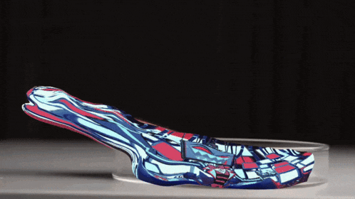 a blue and red object is sitting on a clear container