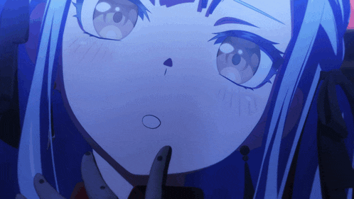 a close up of a person 's face with blue hair