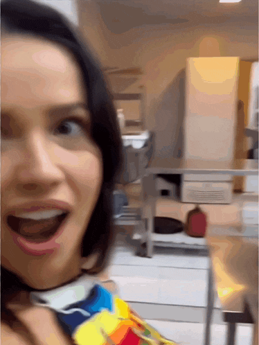 a woman making a funny face in a kitchen