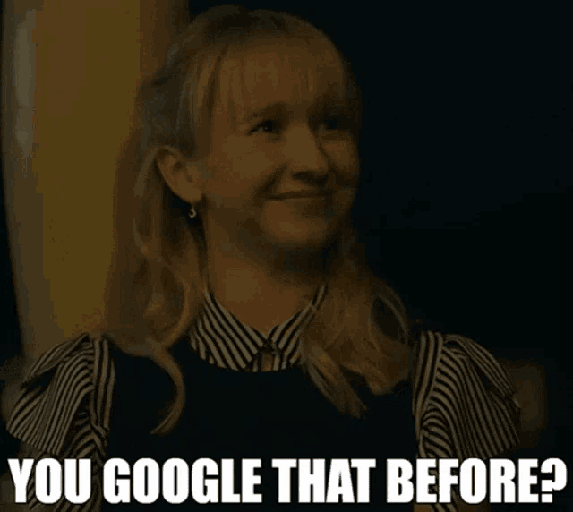 a woman in a striped shirt is smiling and says you google that before