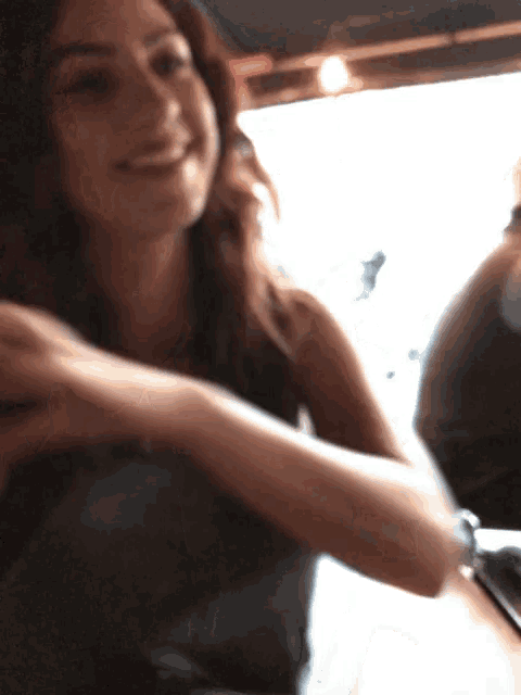 a woman sitting at a table with her arm around another woman 's shoulder