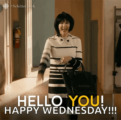 a woman says hello you happy wednesday while holding a black purse