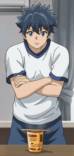 a boy with his arms crossed is standing next to a cup that says noodles on it