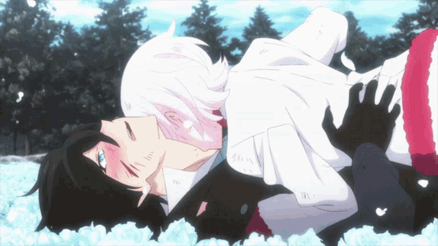a man is holding a woman in his arms and they are kissing in the snow