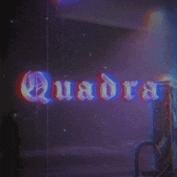 the word quadra is displayed in a dark room