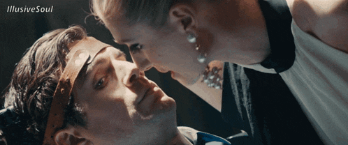 a woman kissing a man 's forehead with the words illusive soul written on the bottom
